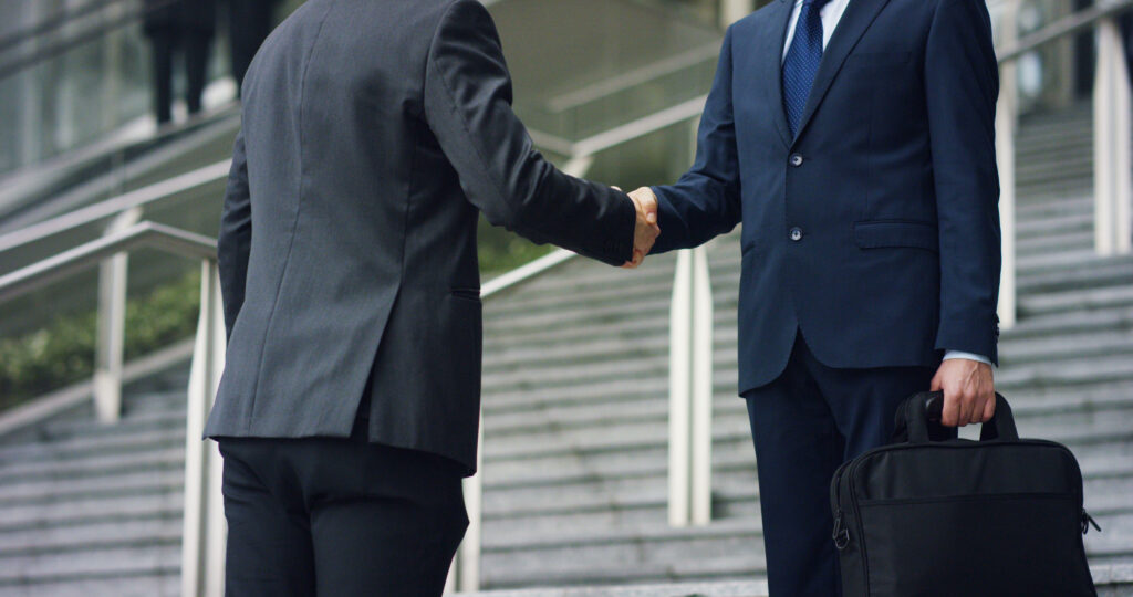 Handshake between financial advisor and client symbolizing trust and transparency