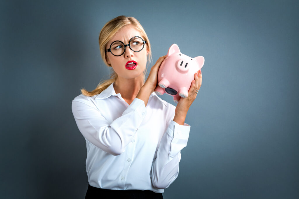 Piggy bank with Roth IRA label and overflowing coins symbolizing Mega Backdoor Roth contributions