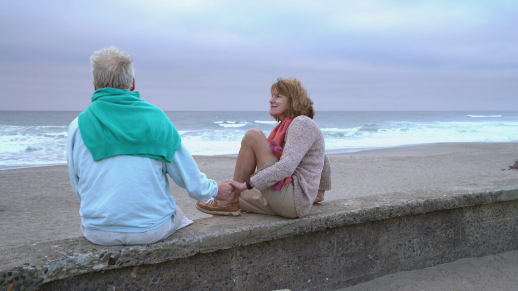 Retired couple relaxing on the beach representing financial comfort in retirement
